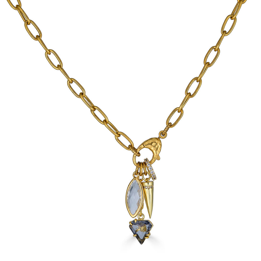 Gold necklace with marquise crystal, spike charm, and smoky gem drop on a textured clasp
