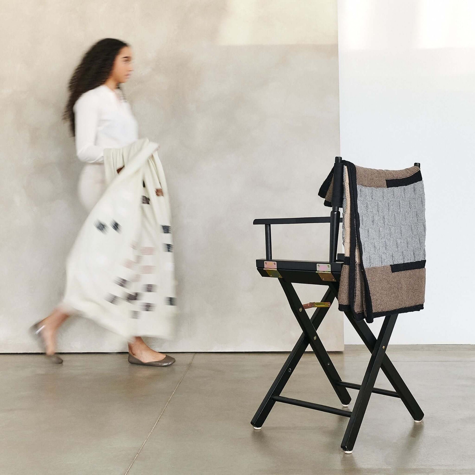 Muthu Brown Gray Hand Knitted Peruvian Alpaca Blanket / Large Plush Scarf displayed on a chair with a woman in motion.