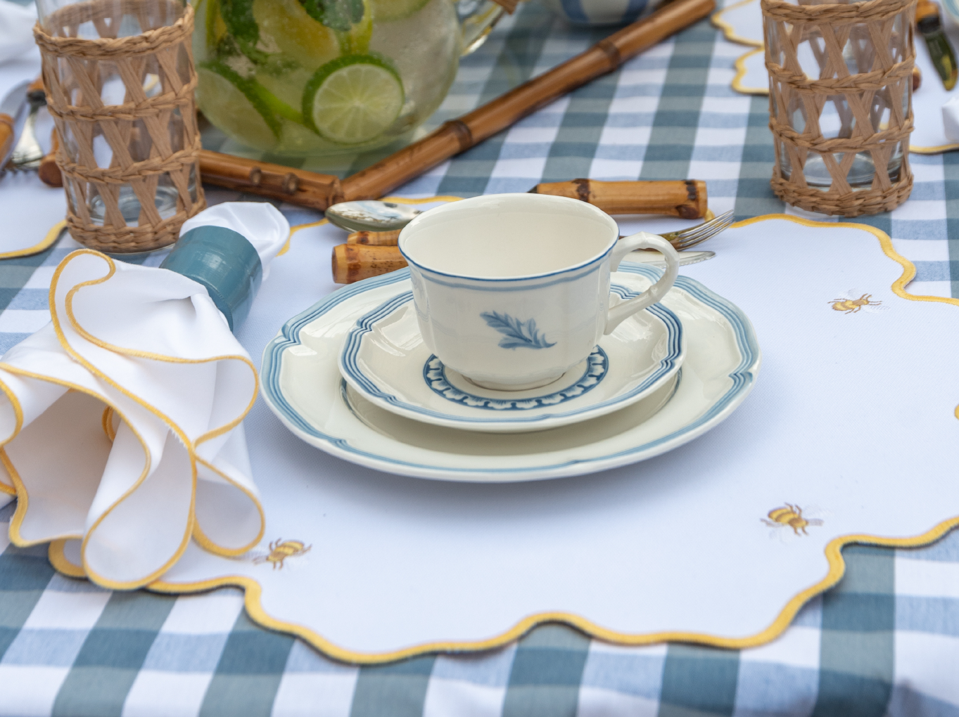 Bumble bee impermeable placemat with hand-stitched bee embroidery and yellow wavy border by Talah Home