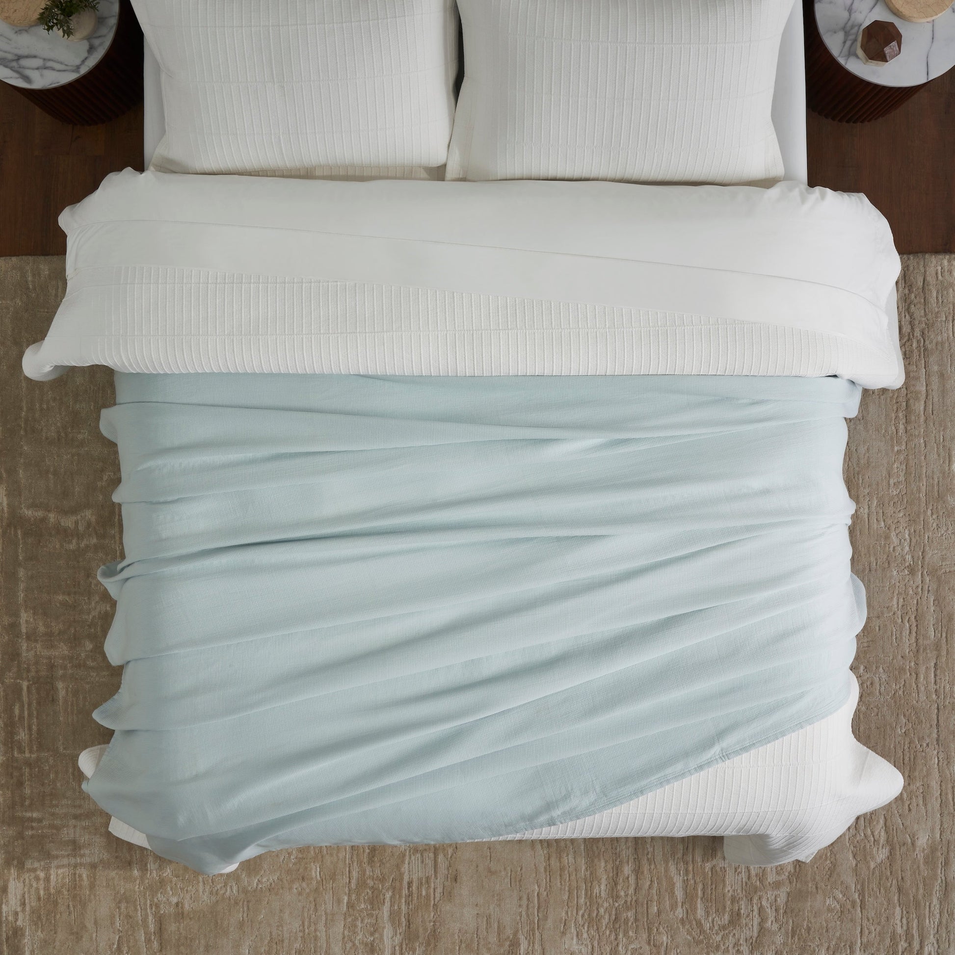 BL-859-9496_4|Aerial view of a light blue waffle weave blanket loosely draped across a white bed. Provides casual comfort and style.