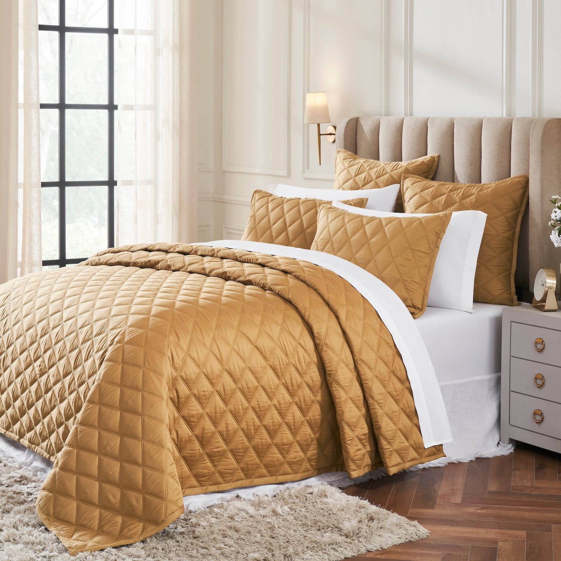 CL-260-9496_2|Elegant golden bronze quilted coverlet and matching pillows adorn a bed, offering a luxurious and cozy bedroom retreat.