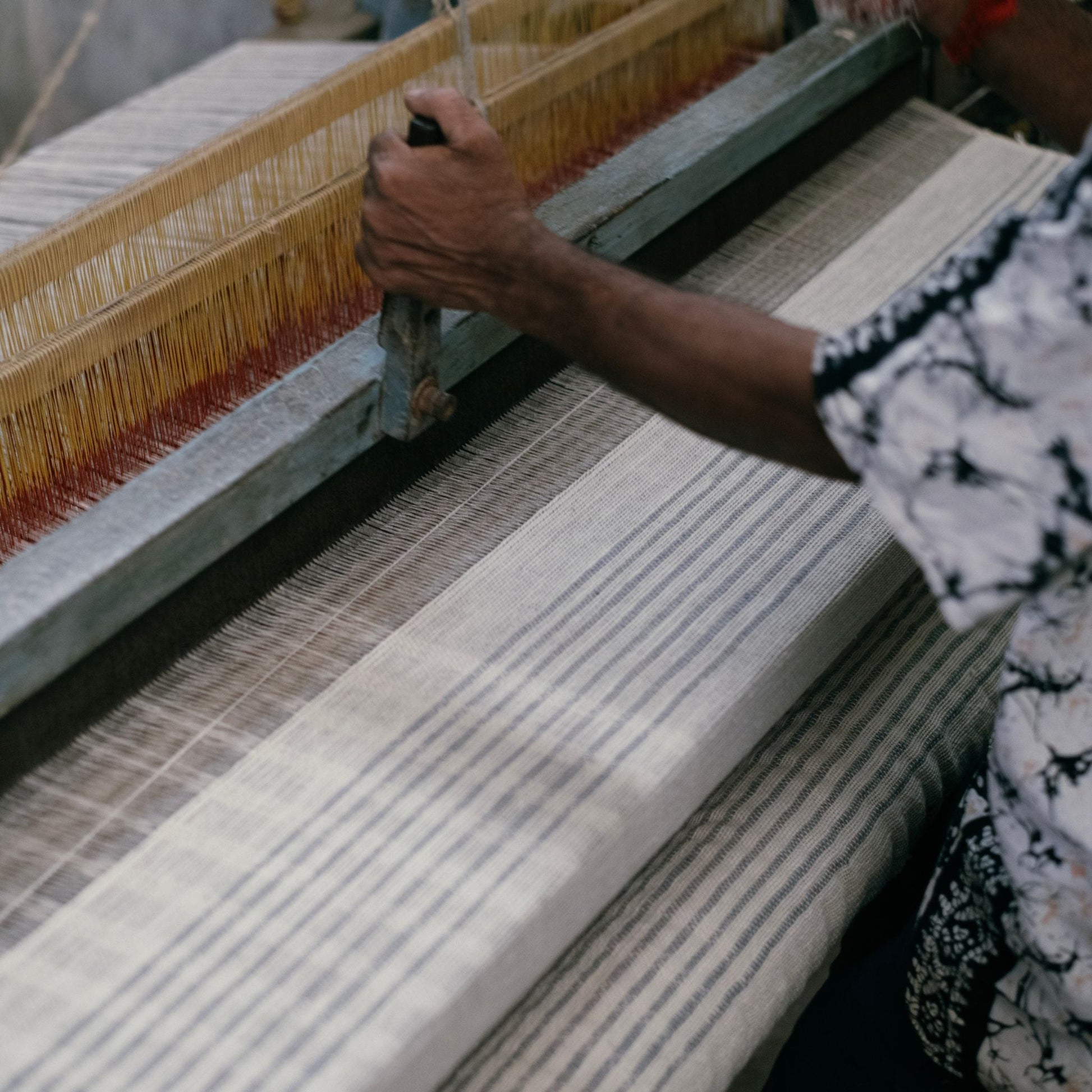 Silica Chalk Off White And Gray Stripes Pattern Soft Handwoven Merino Throw being woven by hand.