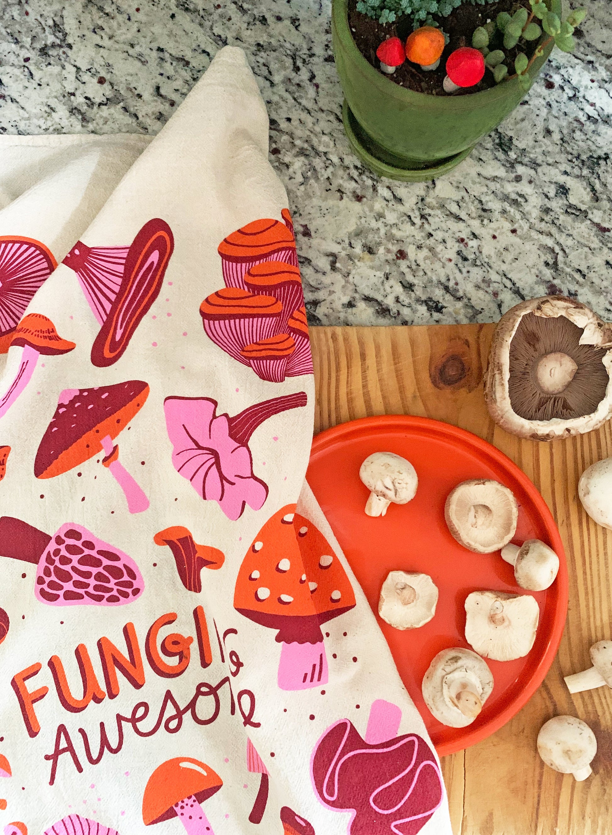 Funging Awesome screen-printed mushroom tea towel on cutting board