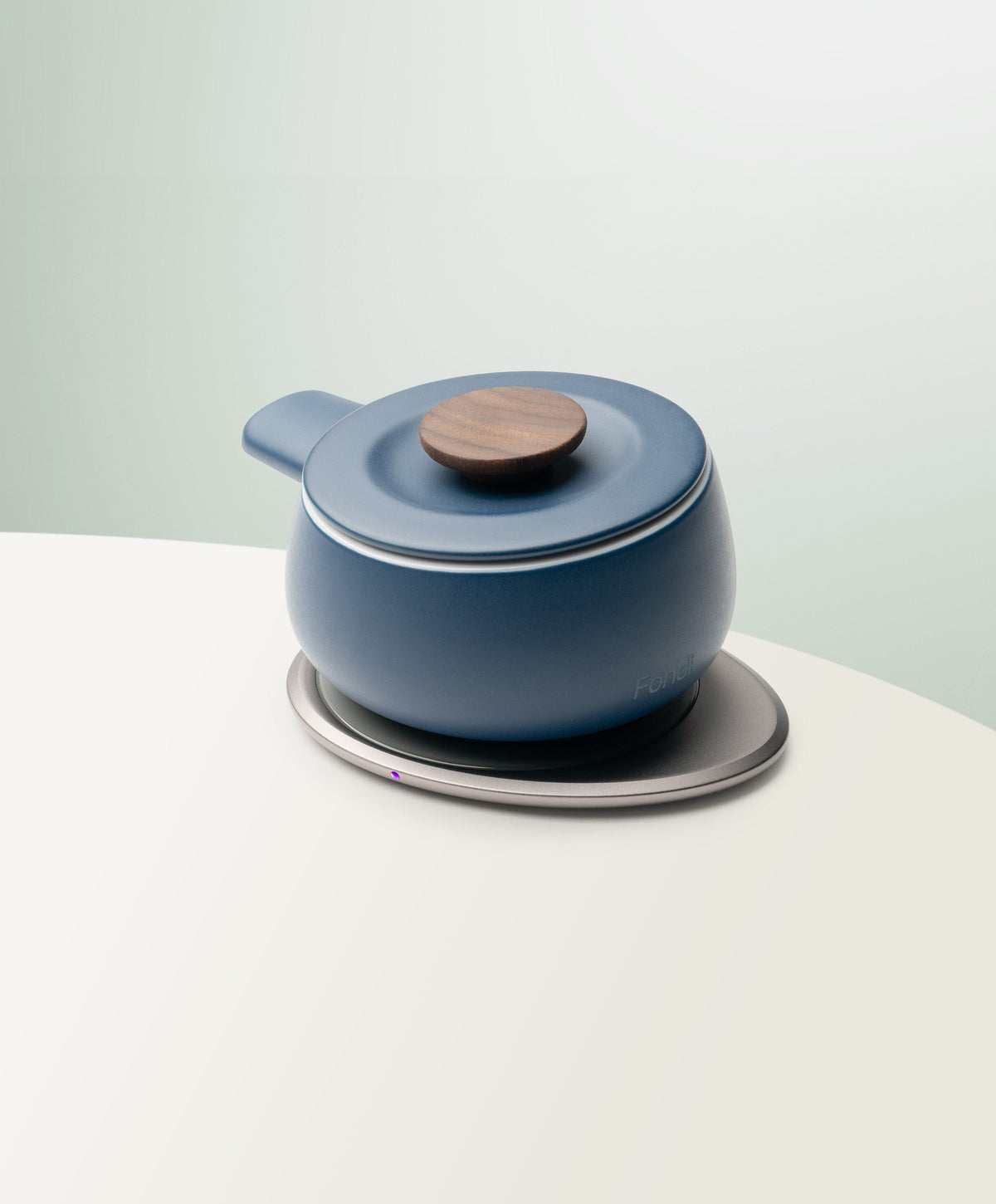 Fondi Self-Heating Ceramic Fondue 7.6 fl oz / 225 mL in Jasmine White angled top-side view on OHOM Charging Pad 3
