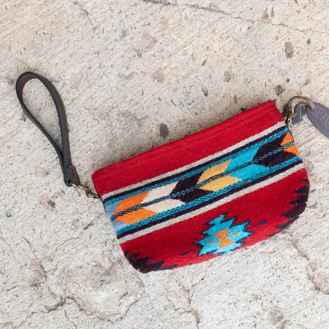 Handwoven convertible clutch with Zapotec pattern in bold colors; can be used as a pouch, wristlet, or crossbody with included leather straps and internal pocket.