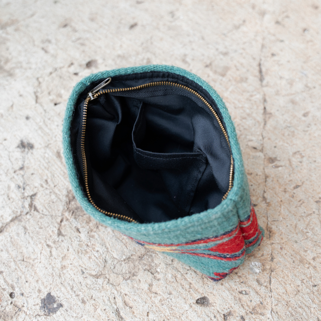 Interior of handwoven pouch with abstract Zapotec arrow design in bold colors featuring internal pocket; perfect for makeup, wallet, or daily essentials.