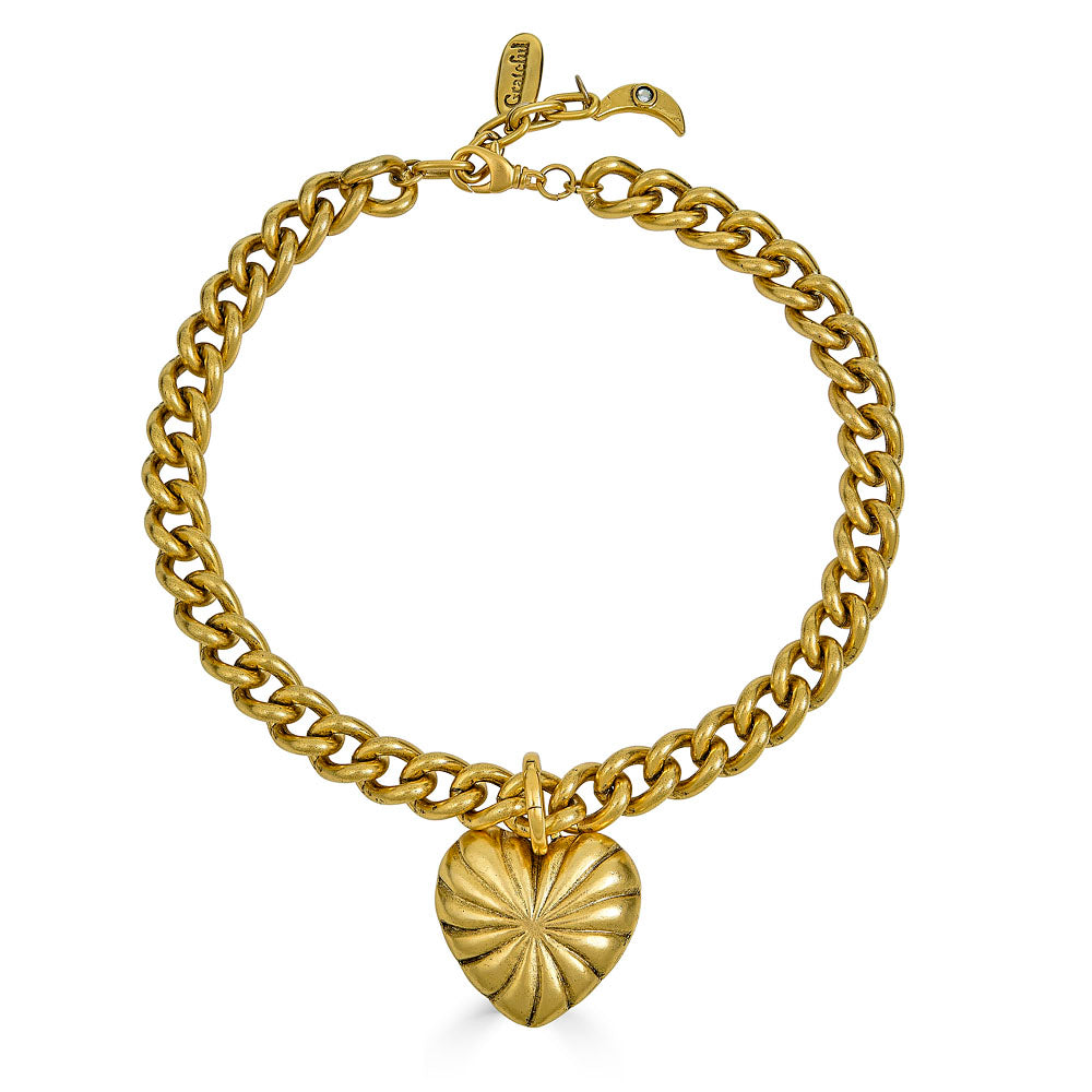 Chunky gold necklace with a large ridged heart charm and “grateful” tag, worn three ways