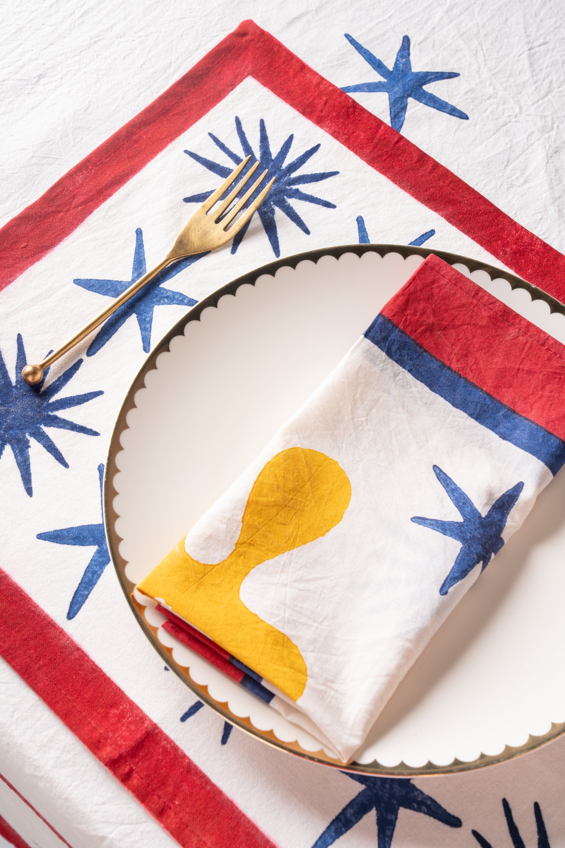 Inner Child Celestial Matisse Blockprint placemat with red border and blue starburst designs