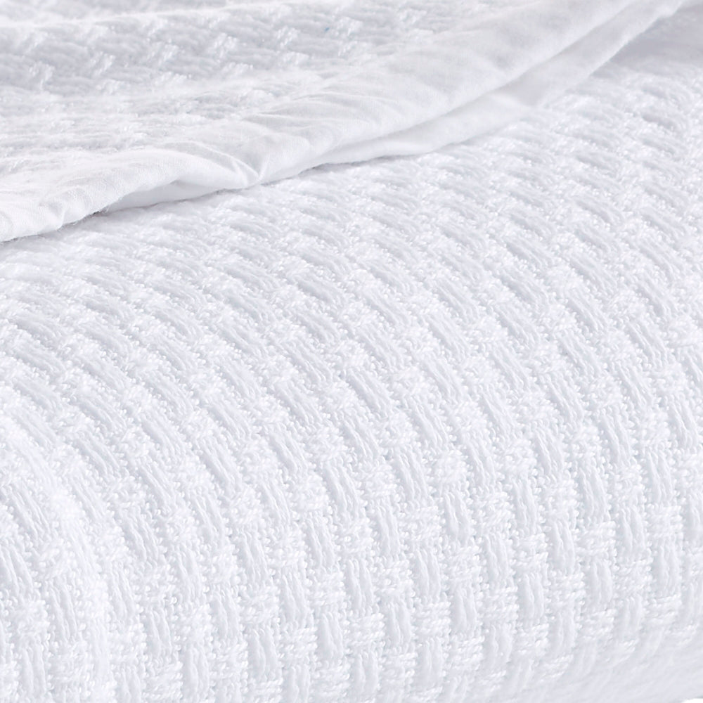 BL-851-11096_4|Detailed close-up of a luxurious white waffle weave blanket, highlighting its intricate texture and soft comfort.