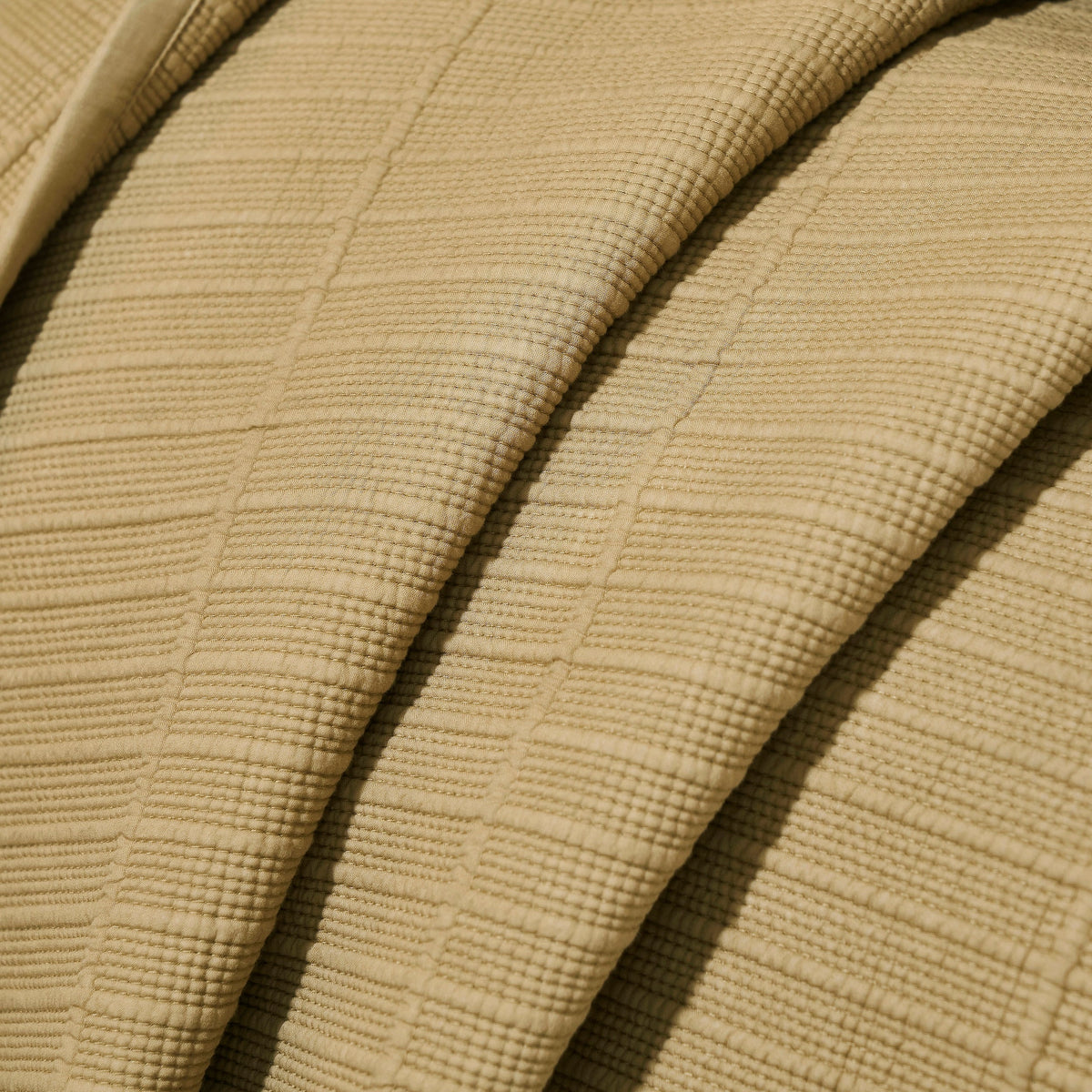 CL-269-11096_8|Detailed close-up of a luxurious beige quilted coverlet fabric, highlighting the rich, intricate texture and soft feel.
