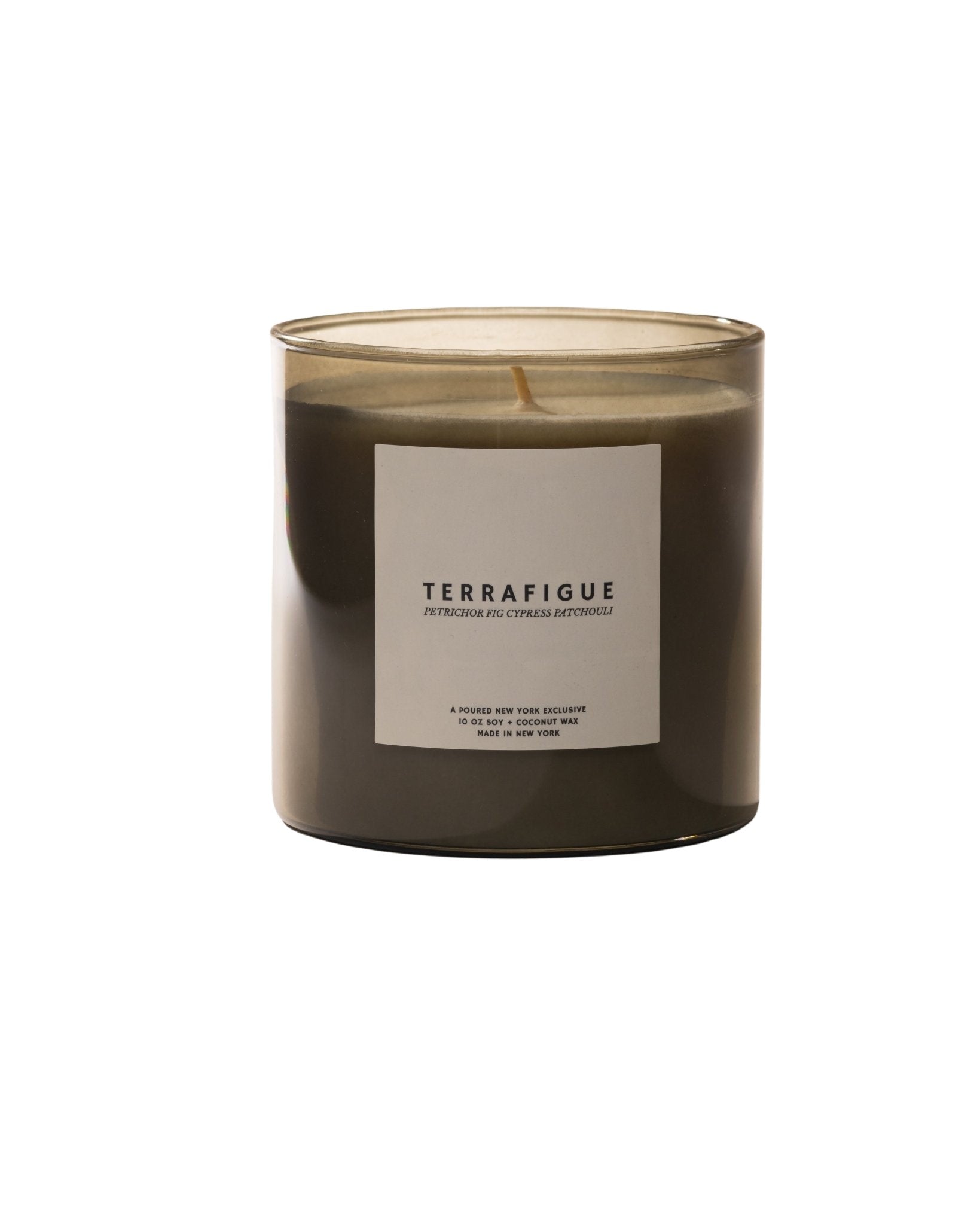 Poured New York 'Terrafigue' candle with a purple box in the background with a fig decal on a light background