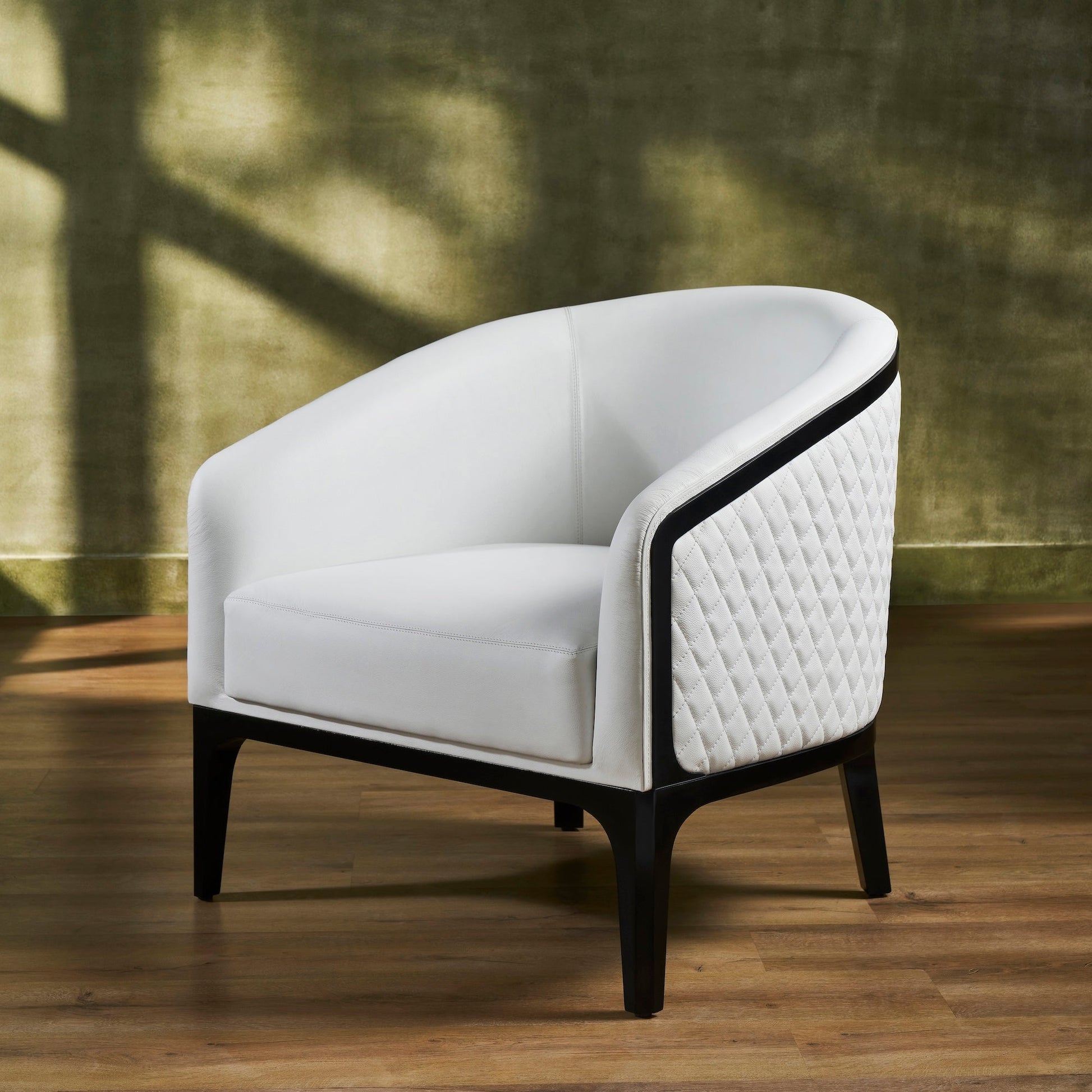 FN-5204-343329_2|Stylish white leather armchair with quilted side panel and dark wood frame, showcasing modern luxury leather furniture.