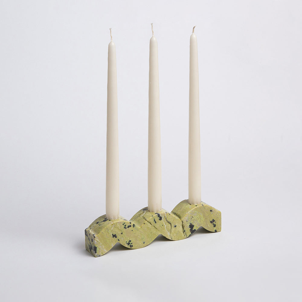 Front view of the solid serpentine green wavy candelabra showcasing its sculptural design on a white background.