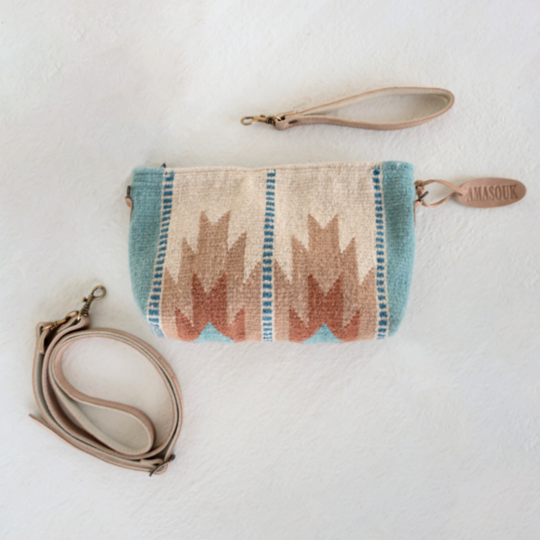 Handwoven convertible clutch with Zapotec lightning design in rose and blue tones; functions as a pouch, wristlet, or crossbody with leather straps and internal pocket