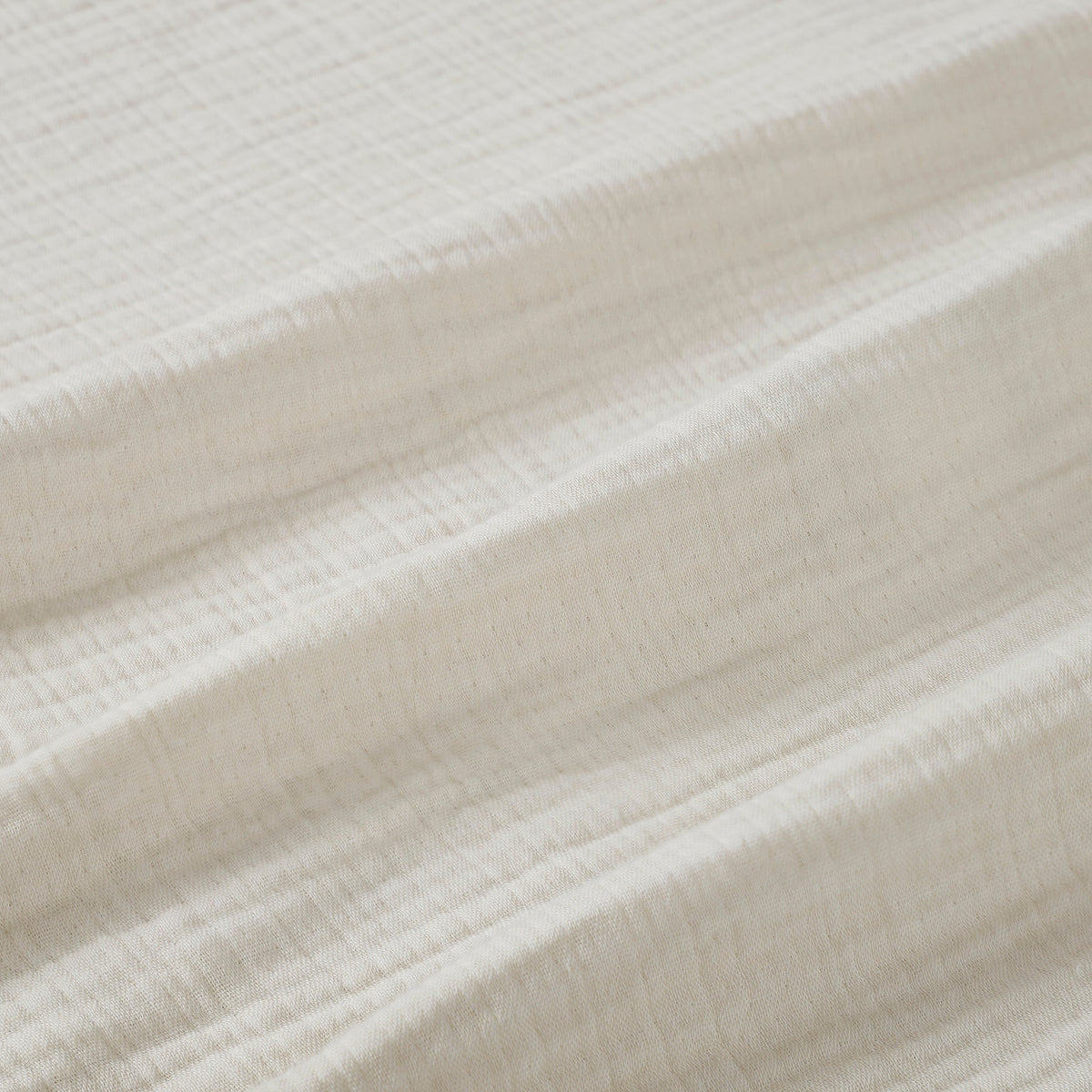 BL-862-11096_9|Close-up view of a soft, textured cream cotton blanket, showcasing its breathable weave and cozy feel for luxurious bedding.