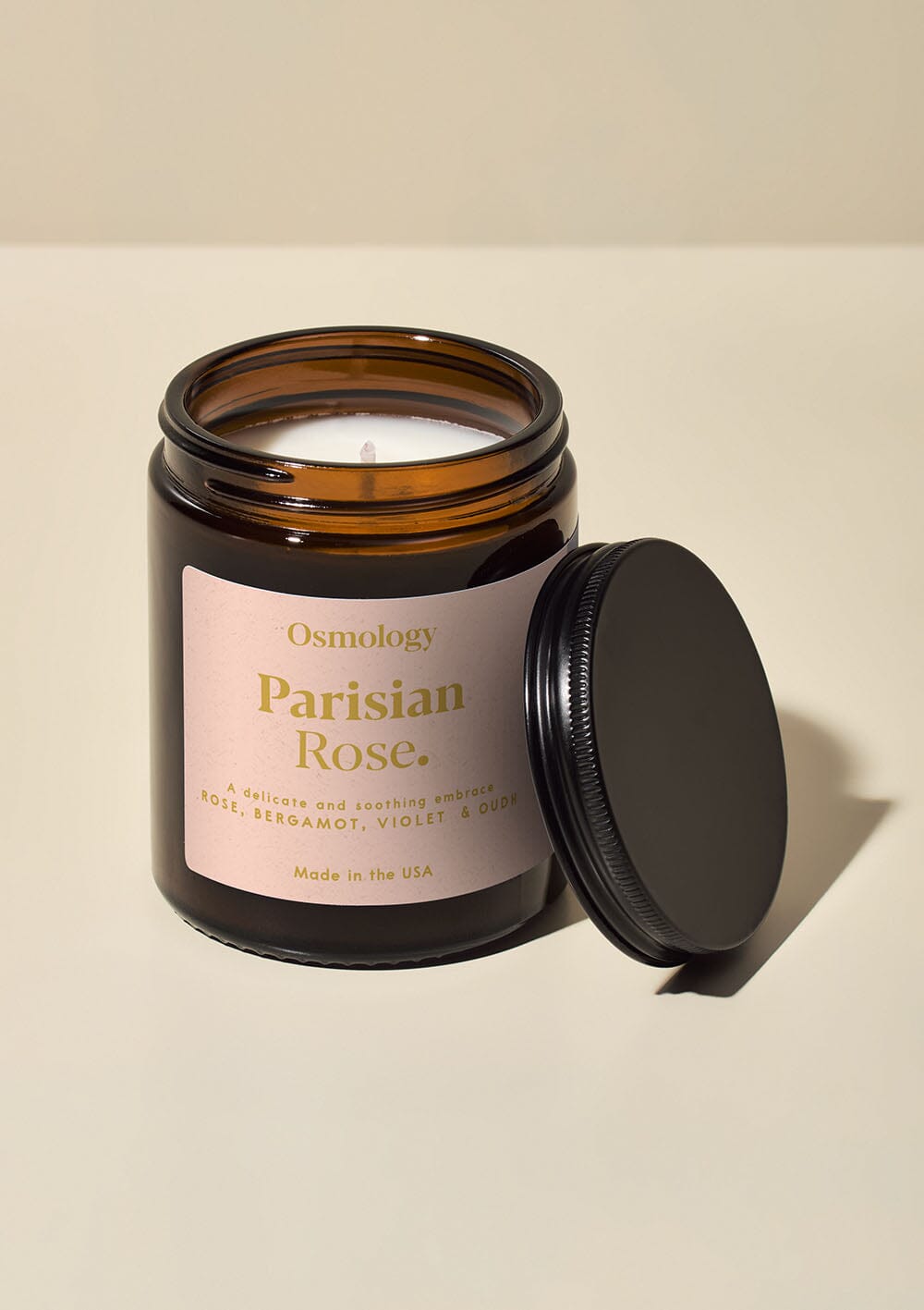 Osmology Parisian Rose jar candle with open on white backgrounf