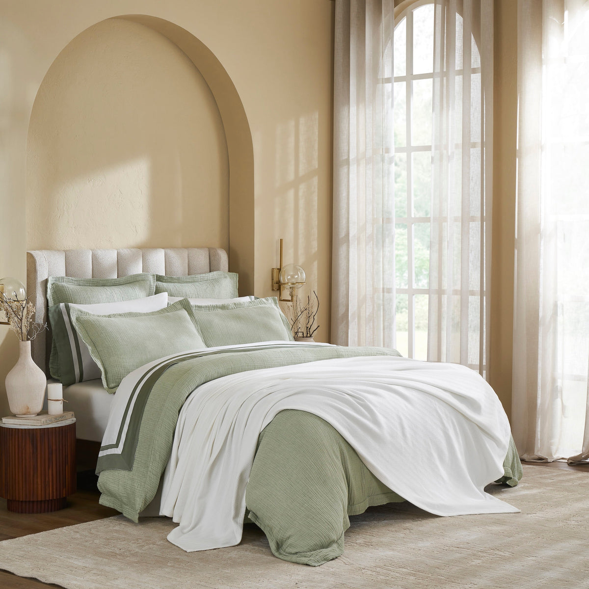 BL-865-11096_3|White textured blanket gracefully draped across a cozy bed with sage green bedding, perfect for comfort and sophisticated decor.