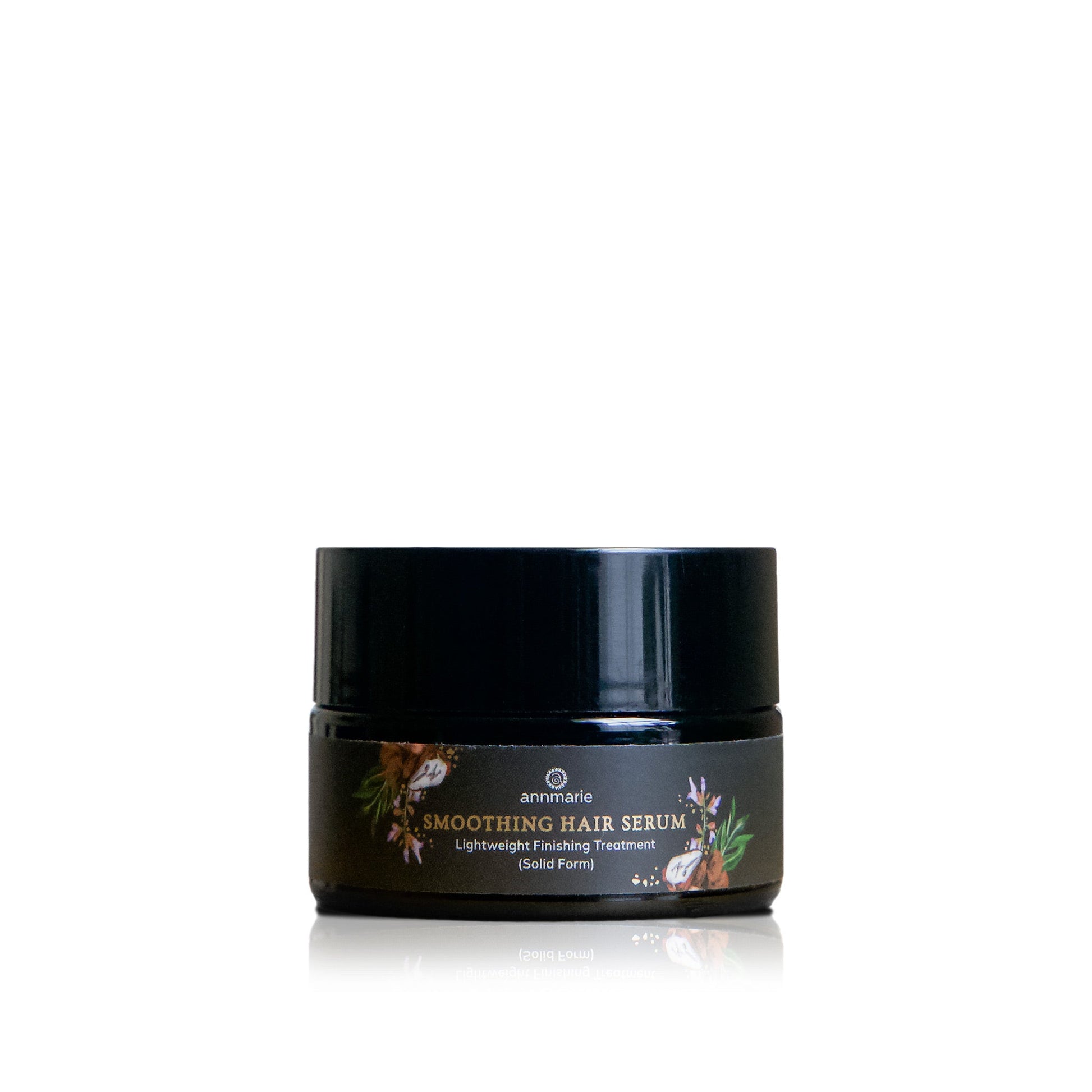 Smoothing Hair Serum lightweight finishing treatment in solid form, black jar with botanical label on a clean white background.