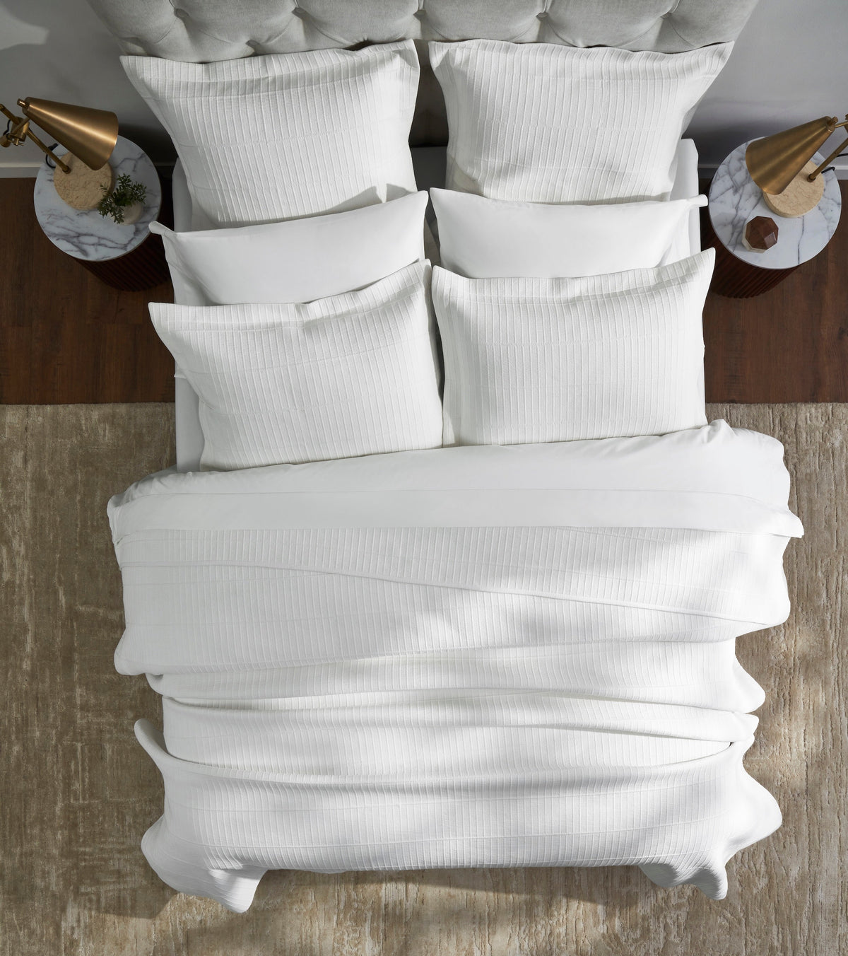 CL-268-11096_3|Luxurious white textured coverlet draping elegantly over a king-size bed, featuring a modern striped pattern for sophisticated bedding.