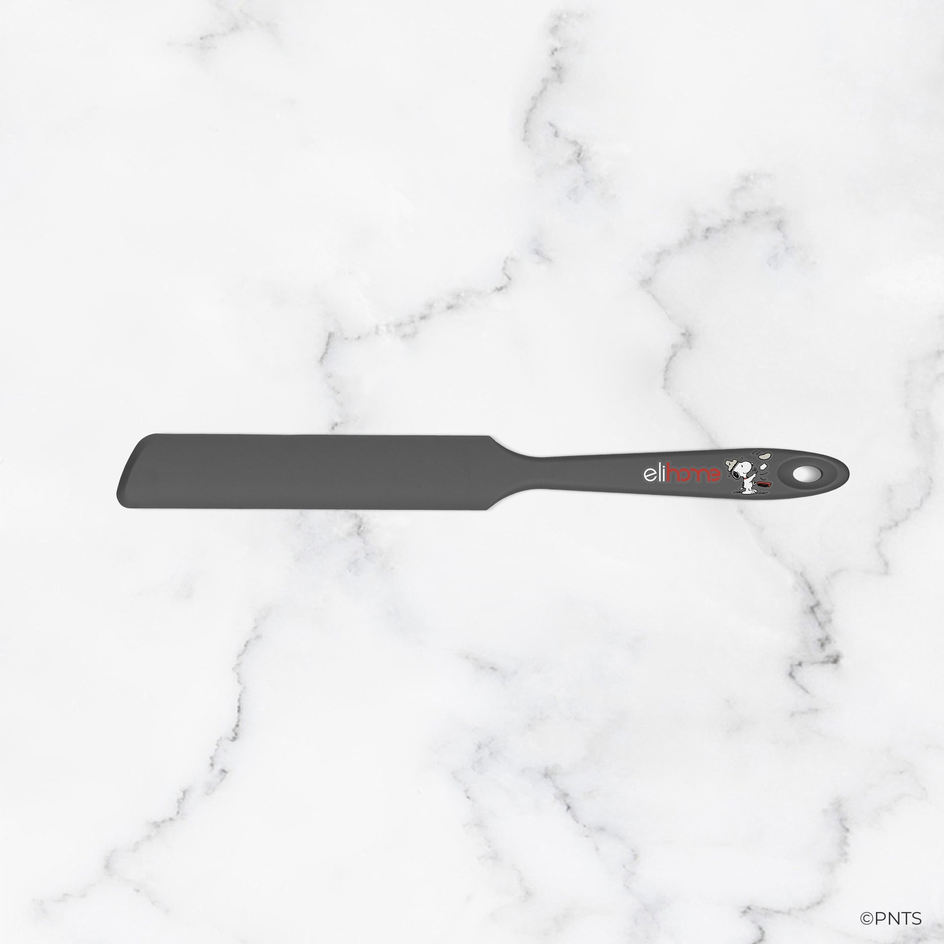 Black spatula with brand logo on a marble background
