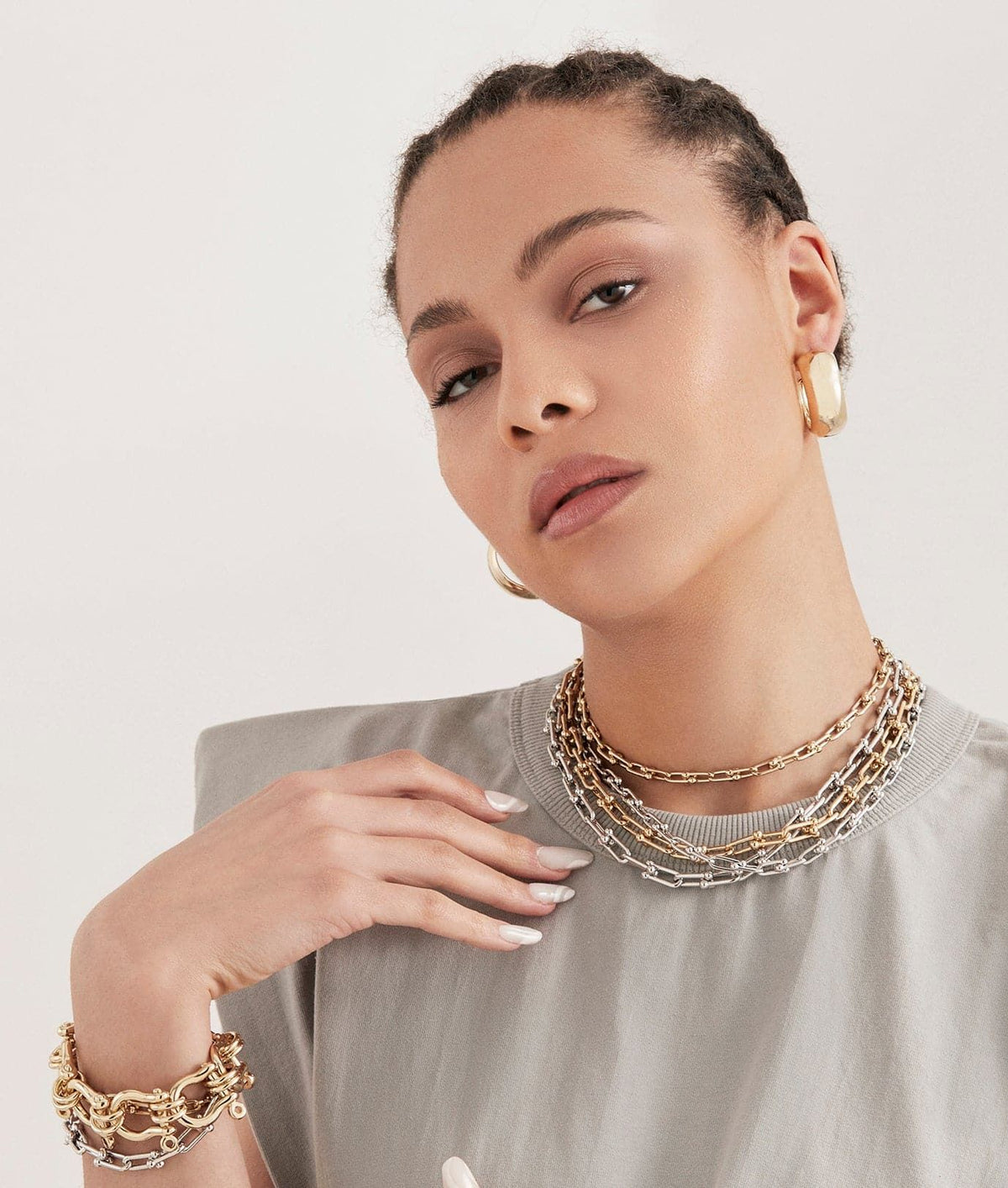 Woman wearing the elegant Margaux Necklace with gold jewelry for a stylish look