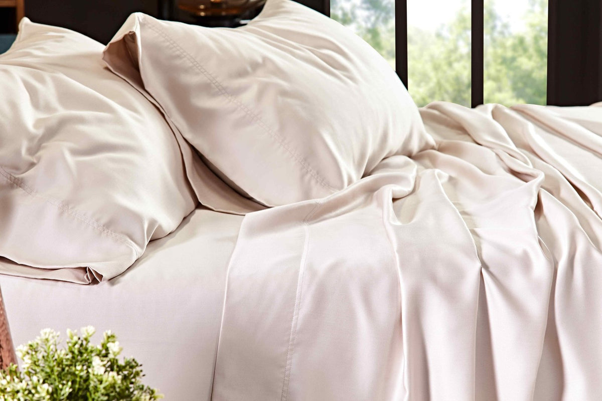 QSS-510-6080_4|Close-up of soft beige 100% Lyocell sheets on a bed, emphasizing the smooth, breathable, and elegant fabric.