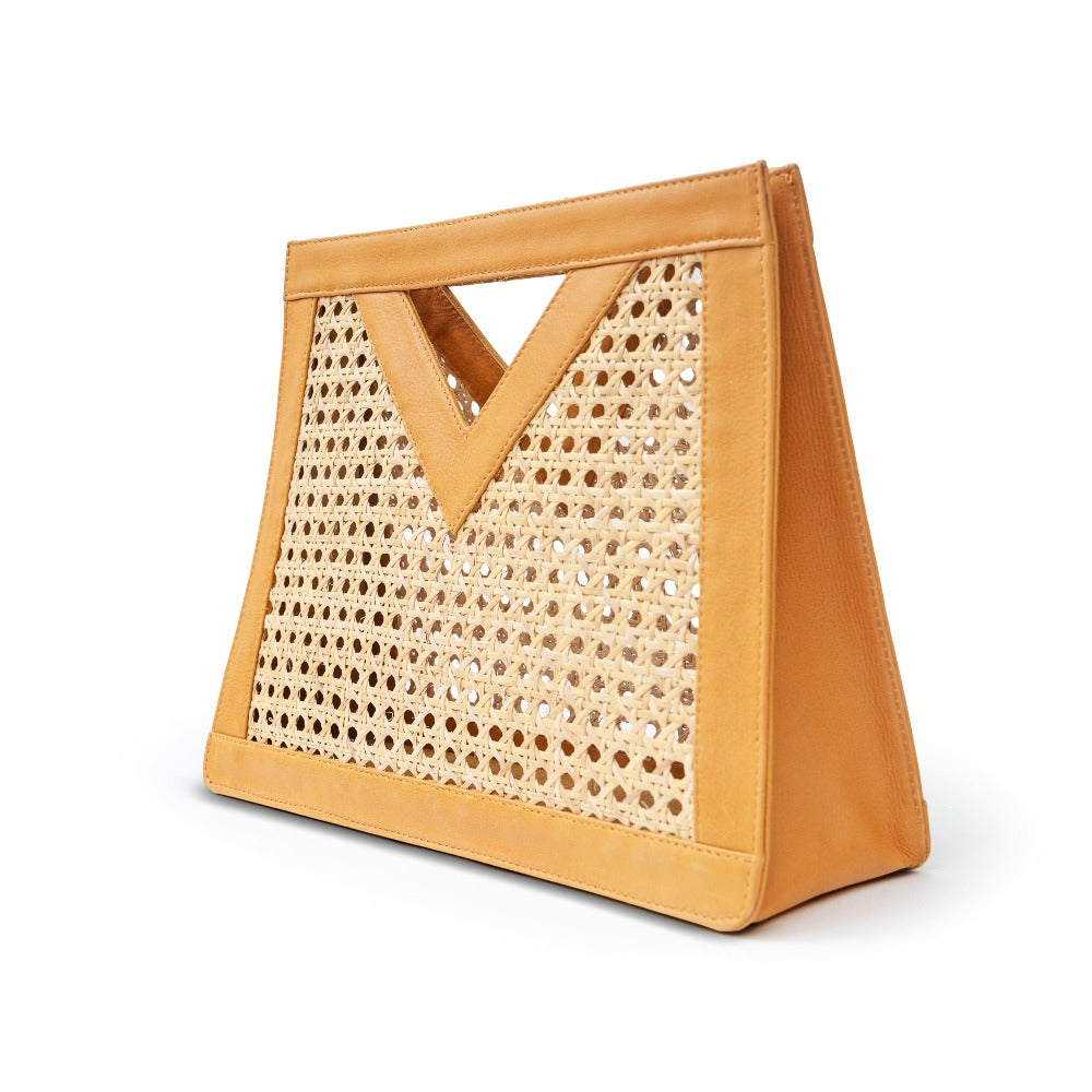 Detail view tan leather and cane webbing rattan top handle tote handbag
