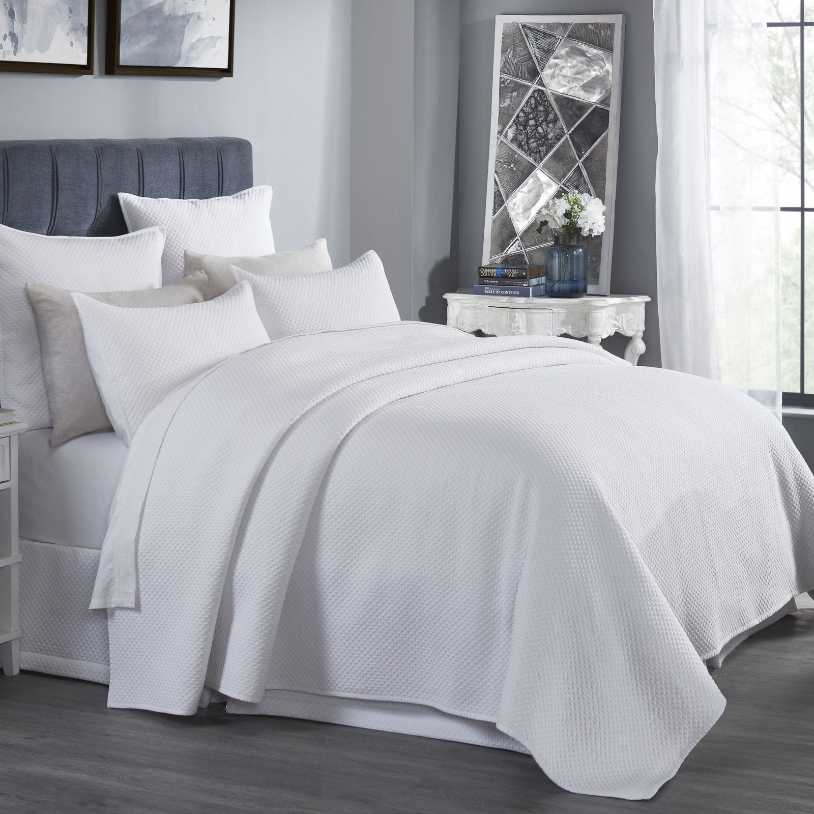 CL-200-9496_2|White quilted coverlet elegantly drapes a queen bed in a bright, modern bedroom, inviting comfort.