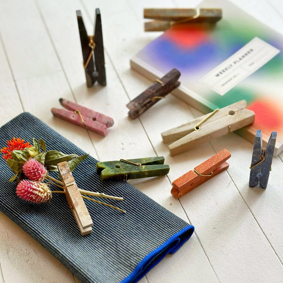 Group display of handcrafted gemstone laundry clips emphasizing their uniform design and quiet luxury appeal.