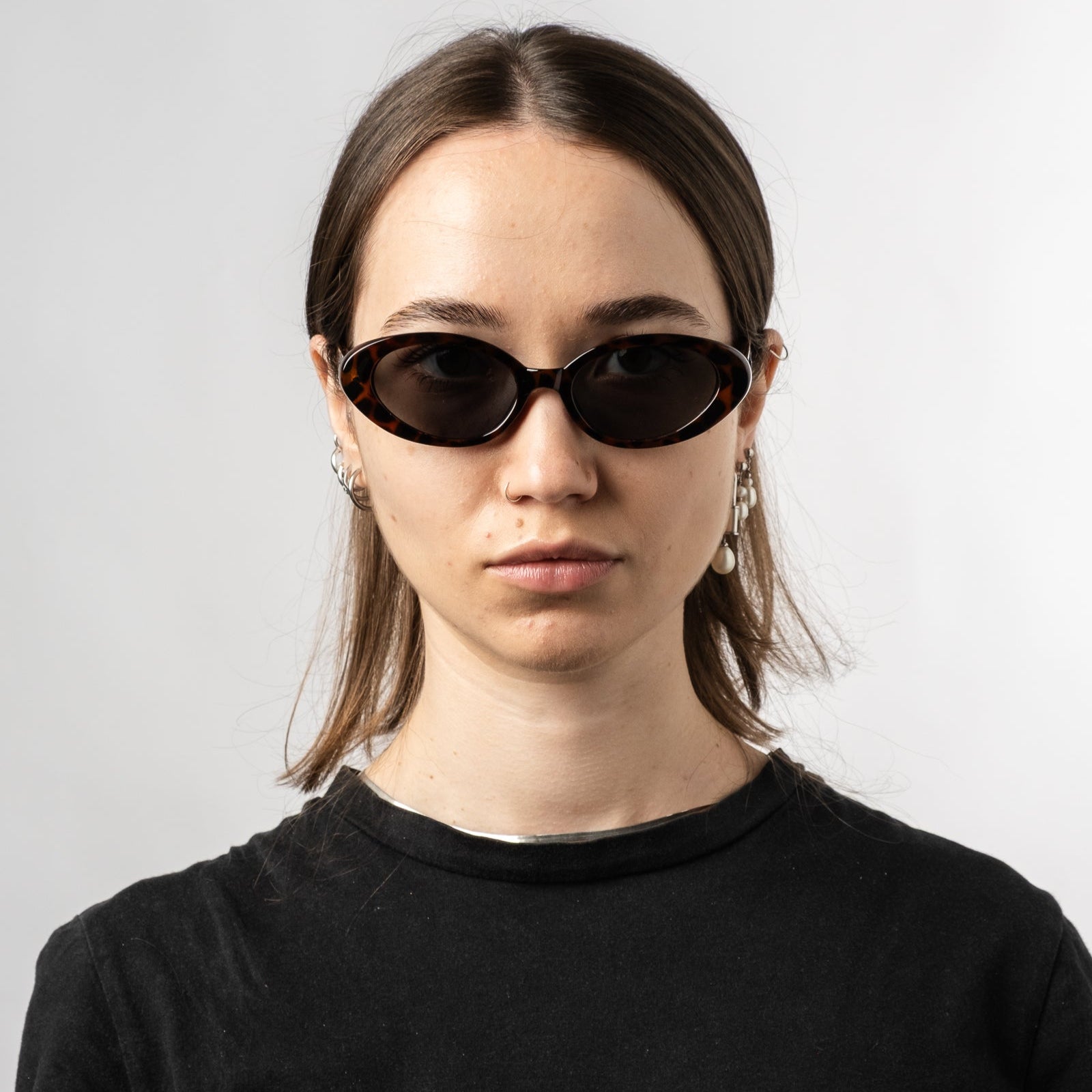 Female wearing Sad Eyewear Bloom oval sunglasses in tortoise with UV protection lenses