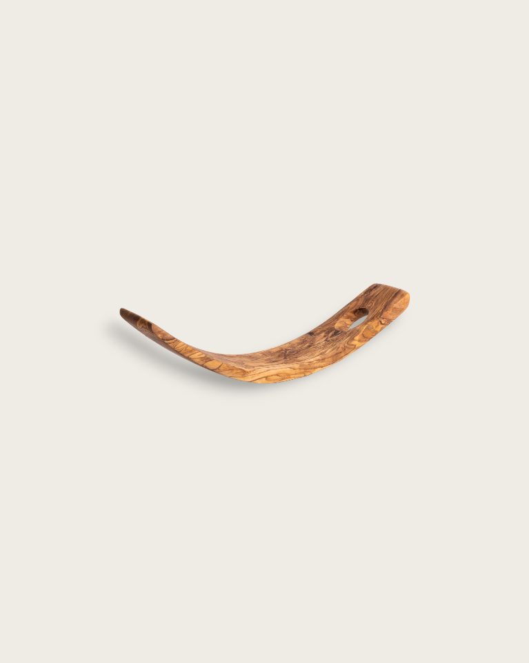 A curved olive wood wine holder holding a wine bottle, displayed against a neutral background.