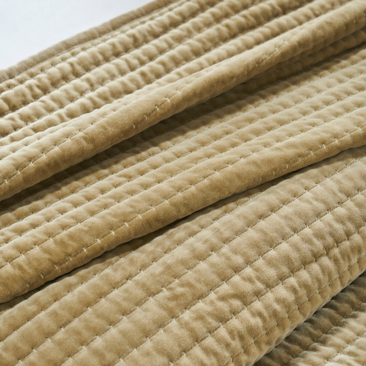 CL-267-11096_7|Neatly folded tan quilted velvet coverlet, showcasing its rich texture and warm color, perfect for cozy bedding.
