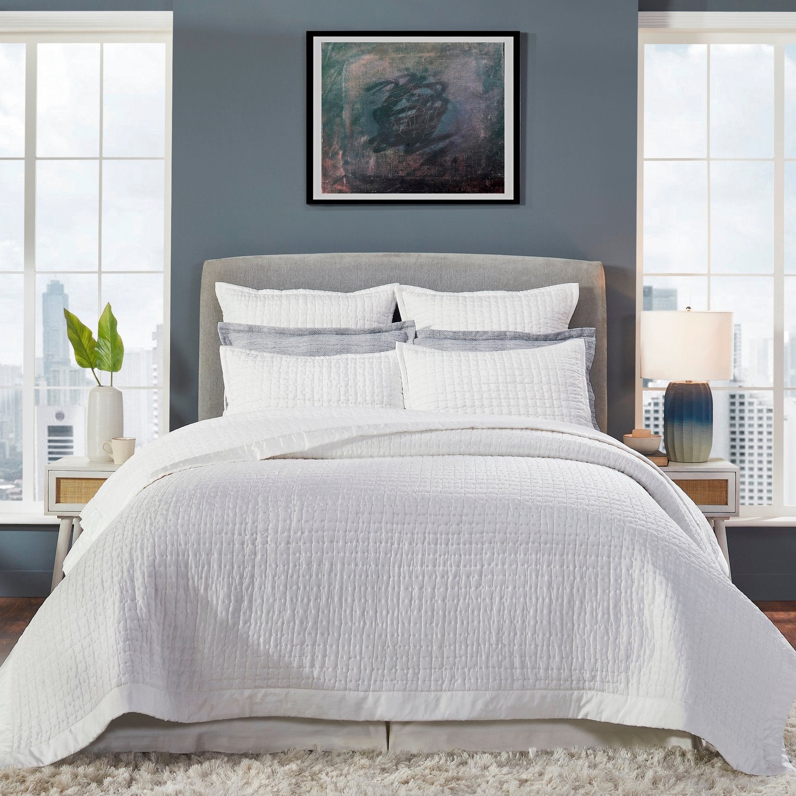 CL-176-DUP-X_1|Crisp white quilted coverlet with a subtle grid pattern on a stylish bed, perfect for modern bedroom aesthetics.