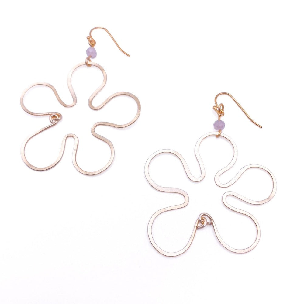 Gold flower earrings modeled