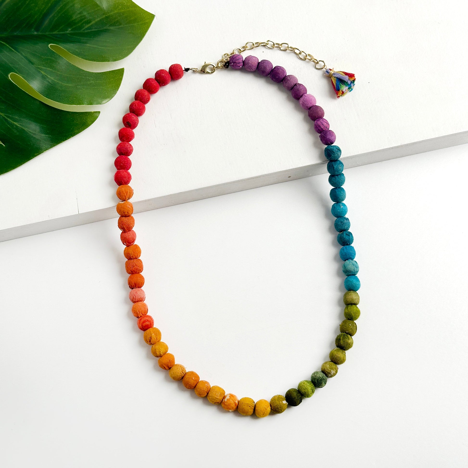 Kantha Prism Nacklace made of beads that have been sorted and arranged into vibrant, color-blocked sections for an multichromatic rainbow-like display of color.
