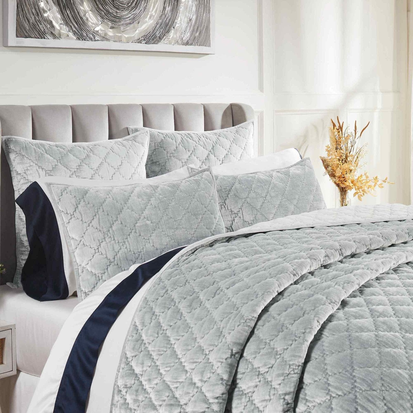 QT-356-9496_3|Close-up of luxurious light grey blue quilt and pillows with diamond quilting. Soft, elegant bedding for a modern bed.