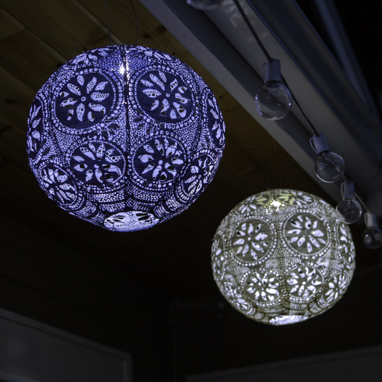 Soji Stella Boho Tyvek Solar Lanterns glowing at night