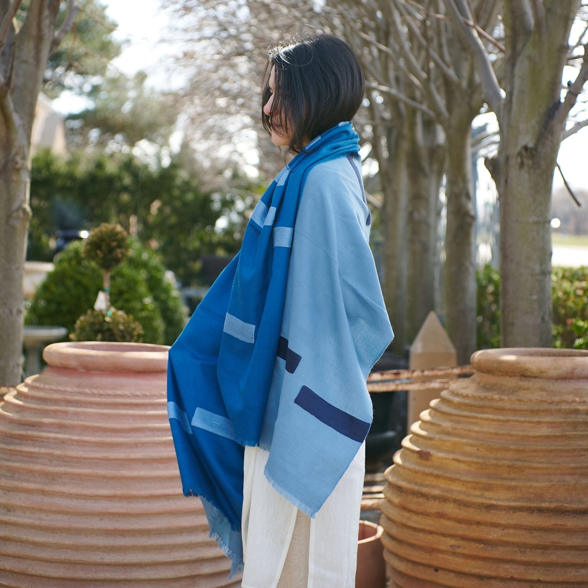 Harbor Blue Silk Merino Hand Woven Hand Embroidered Modern Artisanal Scarf displayed outdoors with a model.