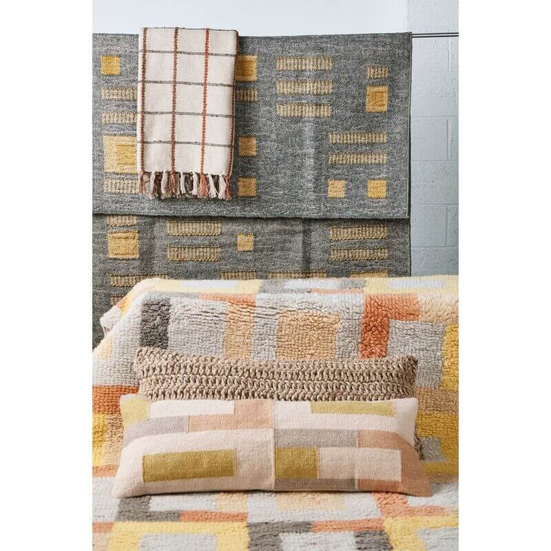 Shale Hand Woven Pastel Color Large Geometric Lumbar Pillow displayed with matching woven blanket and textured decor.