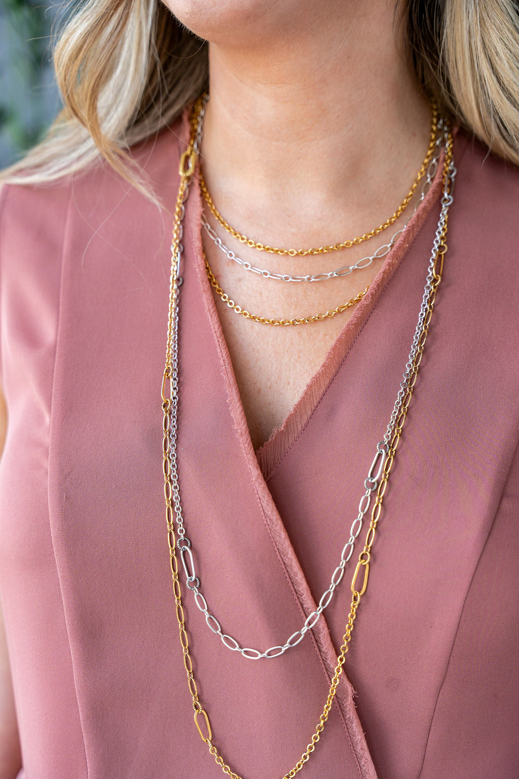 Long gold chain necklace with delicate textured links, designed for layering or doubling