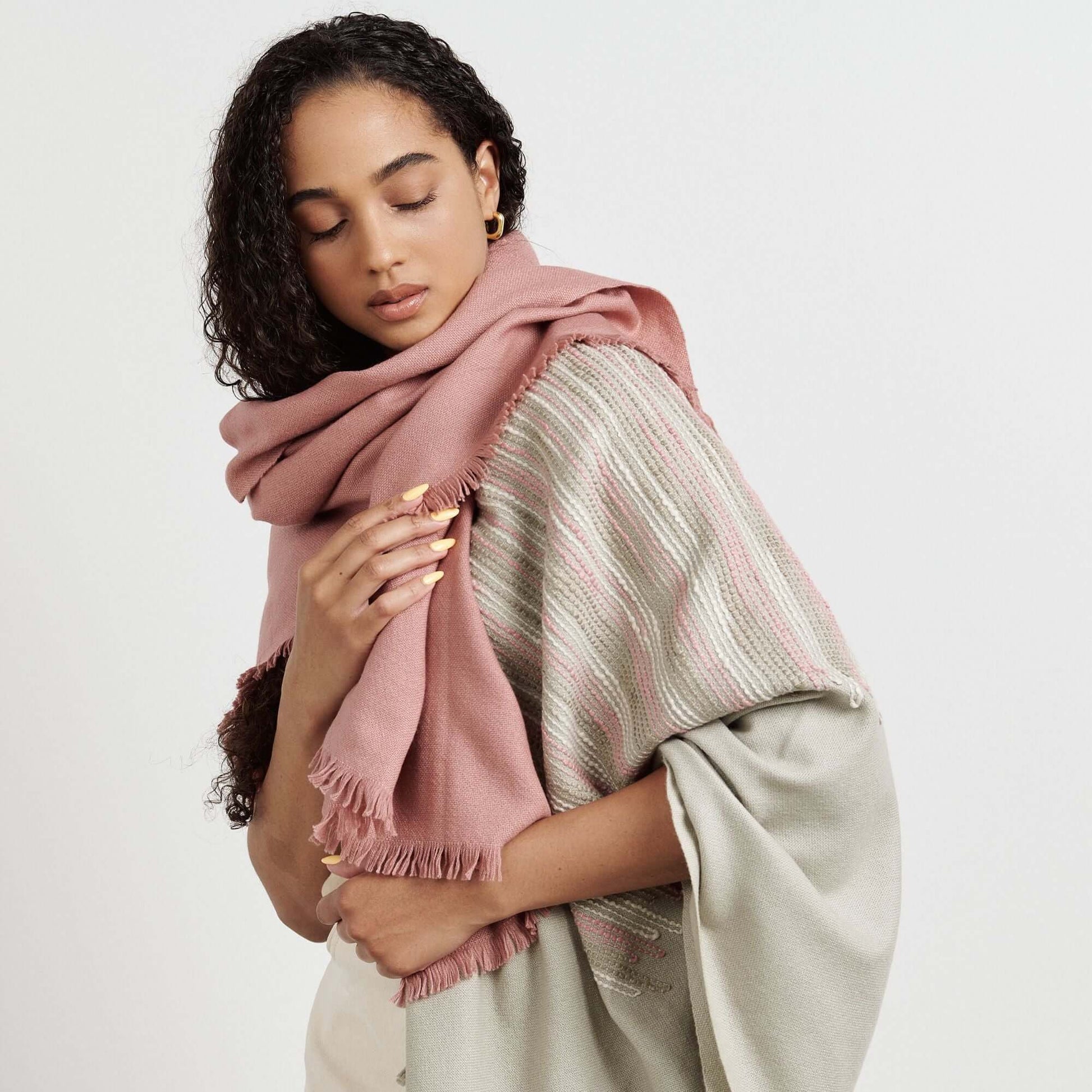 Chive Pink Green Ombre Handloom Merino Throw worn by a model, showcasing its modern design and unique colors.